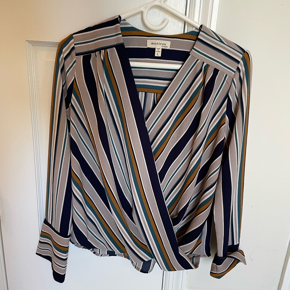 Blouse is navy and tan striped.